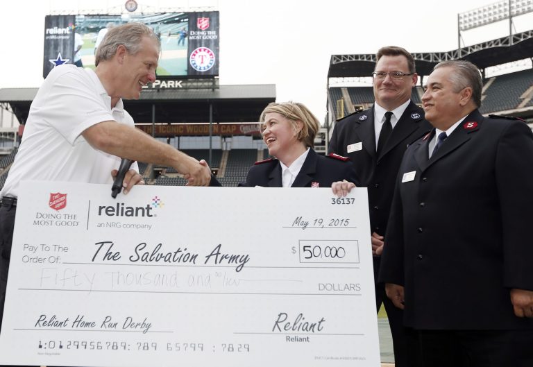Bill Clayton, Executive Director, NRG Retail Charitable Foundation, presents a $50,000 check to The Salvation Army, at the fourth annual Reliant Home Run Derby, Tuesday, May 19, 2015. (AP Photo)Â 