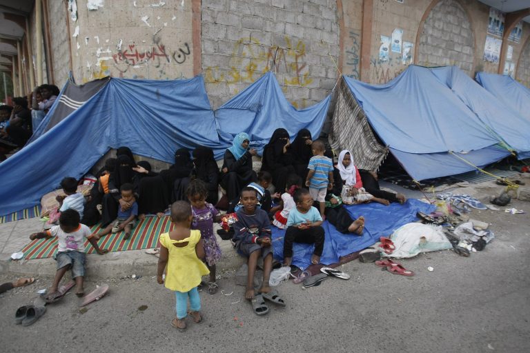 Eritrean female asylum seekers sit along with their children on the sidewalk in Sanaa, Yemen, Friday, June 20, 2014. Since April 29, over 200 Eritrean asylum seekers including women and children living on the streets of Sanaa wait to be resettled to a third country. For the first time since the World War II era, the number of people forced from their homes worldwide has surged past 50 million, the United Nations refugee agency said Friday. (AP Photo/Hani Mohammed)