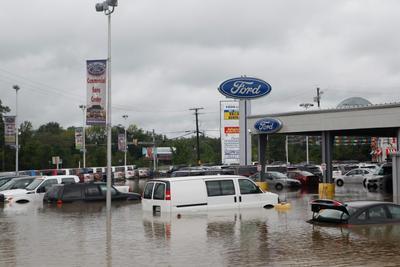 New cars sit submerged in the parking lot of the Ron Bortnick Ford dealership in Upper Marlboro.