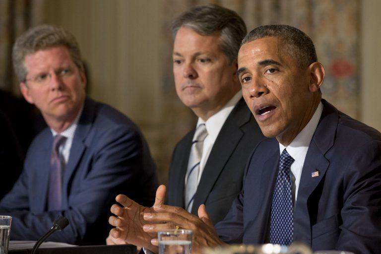 President Barack Obama, accompanied by Budget Director Shaun Donovan, left, and Deputy Assistant to the President and Director of Intergovernmental Affairs David Agnew, speaks about a series of new actions being taken to support communities facing climate change during a meeting with state, local, and tribal leaders, Wednesday, July 16, 2014, in the State Dining Room of the White House in Washington. (AP Photo/Jacquelyn Martin)