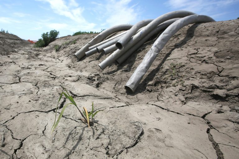 Irrigation pipes sit along a dried irrigation canal in California. (AP Photo/Rich Pedroncelli, File)