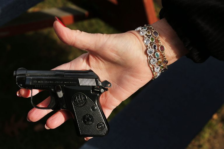 BRIDGEPORT, CT - DECEMBER 22:  A woman holds a Beretta pistol at a gun buyback event at the Bridgeport Police Department's Community Services Division on December 22, 2012 in Bridgeport, Connecticut. (Photo by Spencer Platt/Getty Images)