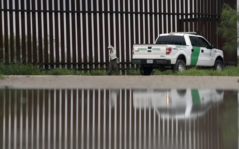 A U.S. Customs and Border Patrol agent passes birdwatcher Nancy Hill, 81, along a section of the border wall Sunday, Nov. 13, 2016, in Hidago, Texas.  