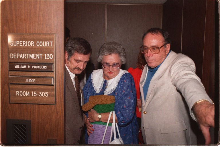 Peggy McMartin Buckey, a defendant along with her son, Raymond Buckey, in the long-delayed McMartin Pre-school molestation trial, is escorted by two unidentified men, as she departs Los Angeles Criminal Courts courtroom after opening statements by the prosecution were completed in this July 13, 1987 photo. Buckey, acquitted in the nation's most protracted criminal molestation case targeting her family's Manhattan Beach preschool, died Friday morning, Dec. 15, 2000 in Torrance, Calif. She was 74(AP Photo/ Lennox McLendon)