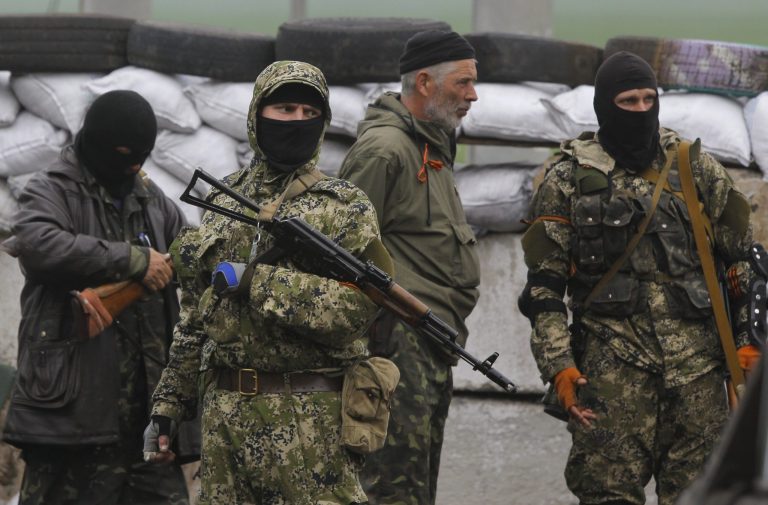 Pro Russian masked armed militants guard barricades near Slovyansk, eastern Ukraine, Wednesday, April 30, 2014. Ukraine's police and security forces are 