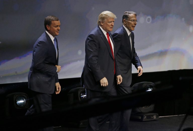Republican presidential candidate Donald Trump is introduced by National Rifle Association executive director Chris W. Cox , left, and NRA executive vice president Wayne LaPierre, right, as Trump takes the stage to speak at the NRA convention Friday, May 20, 2016, in Louisville, Ky. (AP Photo/Mark Humphrey)