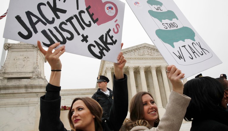 Janae Stracke, left, and Annabelle Rutledge, both with Concerned Women for America, hold up signs in support of cake artist Jack Phillips outside of the Supreme Court which is hearing the 'Masterpiece Cakeshop v. Colorado Civil Rights Commission,' Tuesday, Dec. 5, 2017, in Washington.