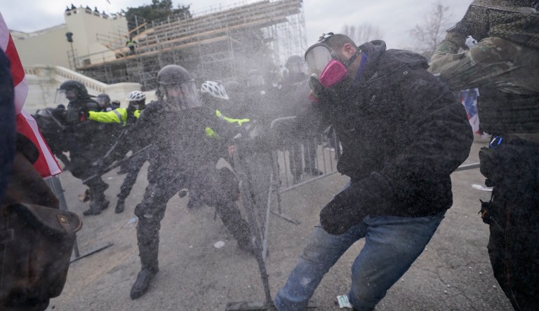 Supporters of then-President Donald Trump try to break through a police barrier at the Capitol in Washington on January 6, 2021. 