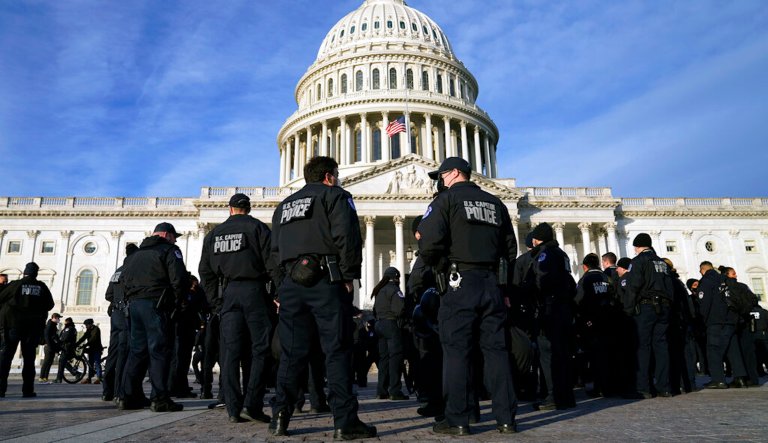 FILE - A large group of police arrive at the Capitol, Jan. 6, 2022, in Washington.  U.S. Capitol Police officers are facing increasingly heated rhetoric from House Republicans as it tries to win back public confidence, including baseless allegations that the departmentâs officers are operating as politically driven spies.
