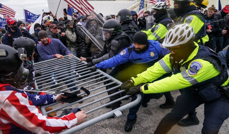 In this file photo from Wednesday, Jan. 6, 2021, Trump supporters beset a police barrier at the Capitol in Washington. A 19th person from Ohio has been arrested in Alabama for allegedly convening a caravan of people from Virginia to Washington on Jan. 6 and assaulting police officers during the deadly Capitol riots. 
