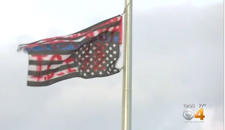 A flag has the words "Abolish I.C.E." spray-painted on it in Aurora, Colorado.