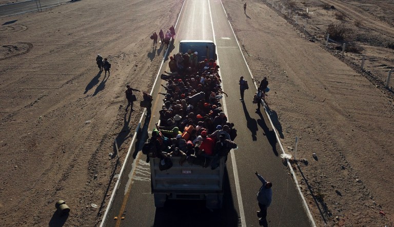 Central American migrants get a ride on a truck going from Mexicali to Tijuana, Mexico, Tuesday, Nov. 20, 2018. Migrants camped in Tijuana after traveling in a caravan to reach the U.S weighing their options after a U.S. court blocked President Trump's asylum ban for illegal border crossers.