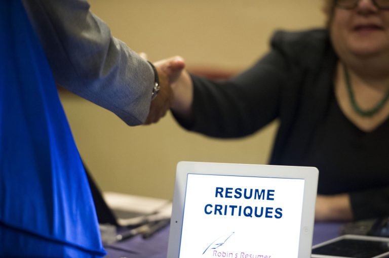 A job seeker stops at a table offering resume critiques during a job fair held in Atlanta. (AP/John Amis)