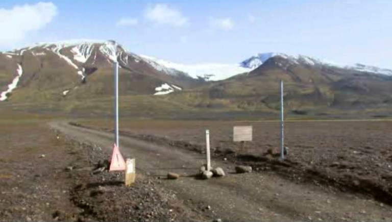 FILE - This is a Aug. 19, 2014 file image taken from video of  a sign is posted on the road next to Bardarbunga, a subglacial stratovolcano located under Iceland's largest glacier.  Earthquakes are rocking Iceland's Bardarbunga volcano, adding to concerns that magma movements may trigger an eruption that could hinder air traffic. Iceland's Met Office says two earthquakes measuring over magnitude 5 shook the volcano under the vast Vatnajokull glacier on Wednesday Aug. 27 2014. Some 500 quakes have hit the area since midnight.  (AP Photo/Courtesy Channel 2 Iceland, File) ICELAND OUT