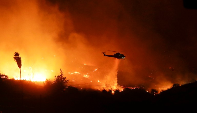 The wind-swept blazes have forced tens of thousands of evacuations and destroyed dozens of homes in Southern California. California Gov. Jerry Brown sent a letter to the president requesting the emergency declaration, which would unlock federal resources for Los Angeles, Riverside, San Diego, Santa Barbara, and Ventura counties. (AP Photo/Gregory Bull)