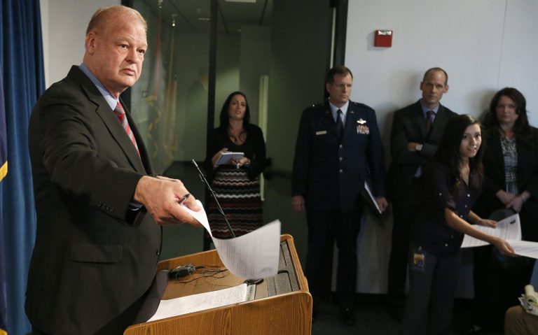 Arizona Attorney General Tom Horne, left, and the state have reached a settlement agreement with an employee in his office who claimed she faced retaliation after telling the FBI Horne may have violated campaign finance laws. (AP/Ross D. Franklin)
