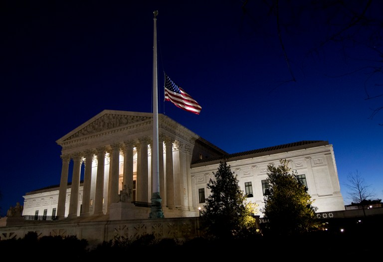 An American flag flies at half-staff in front of the U.S. Supreme Court building in Washington, as the sun rises Sunday, Feb. 14, 2016, in honor of Supreme Court Justice Antonin Scalia. (AP Photo/Manuel Balce Ceneta)