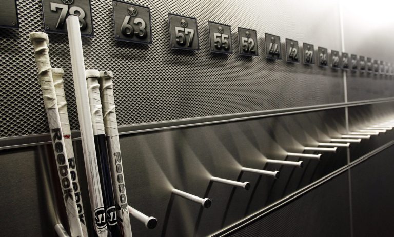   FILE - In this Sept. 25, 2012 file photo, a nearly empty hockey stick rack in the locker room of the Buffalo Sabres hockey team is shown during the NHL labor lockout in Buffalo, N.Y. The NHL lockout that's already wiped out the first three months of the season is taking its toll on Buffalo businesses. And it's no different in many of the NHL's 29 other markets. (AP Photo/David Duprey, File)  