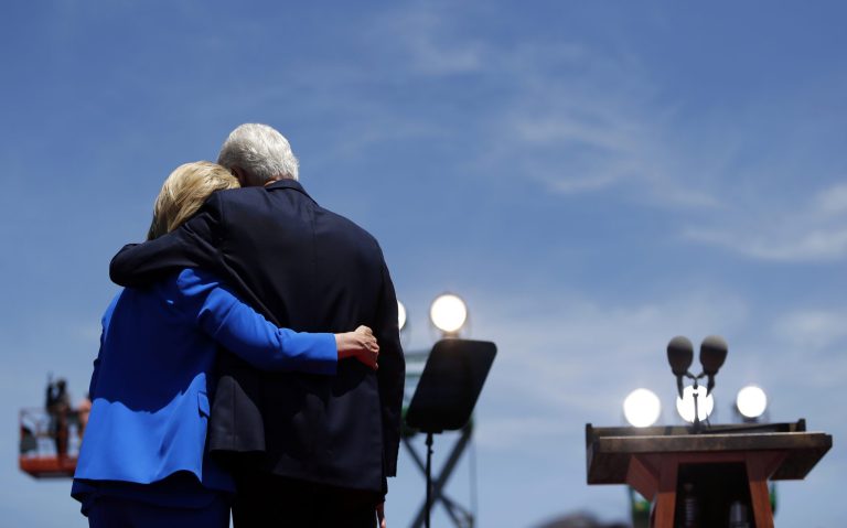 Democratic presidential candidate, former Secretary of State Hillary Clinton, left, is hugged by her husband, former President Bill Clinton, after speaking to supporters Saturday, June 13, 2015, on Roosevelt Island in New York. (AP Photo/Julio Cortez)