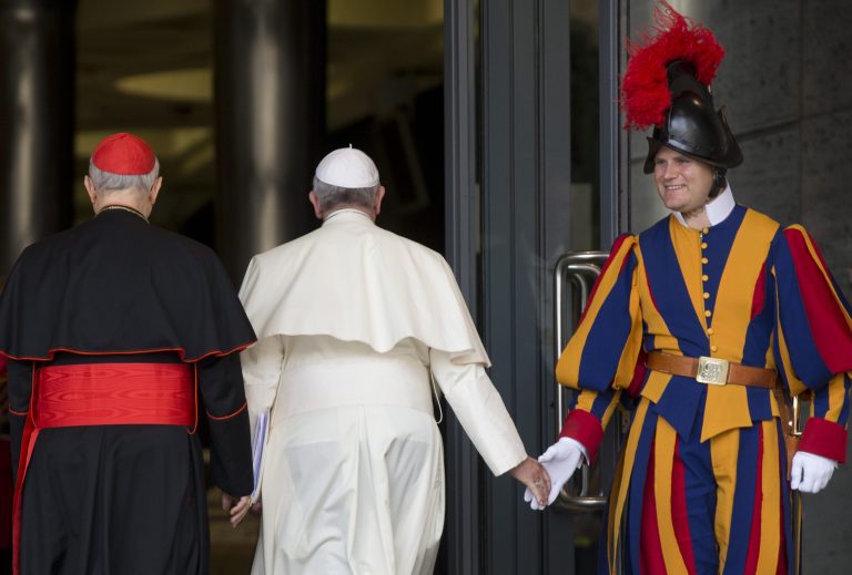 Pope Francis greets a Vatican Swiss Guard as he arrives for a morning session of a two-week synod on family issues, at the Vatican, Thursday, Oct. 16, 2014. (AP Photo/Alessandra Tarantino)