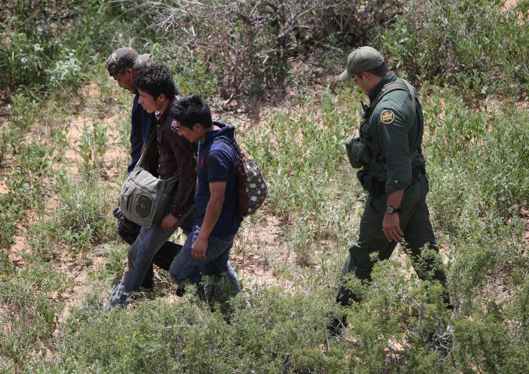 U.S. Border Patrol agents detain undocumented immigrants in the brush on September 11, 2014 near Falfurrias, Texas. (Photo by John Moore/Getty images)