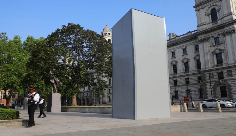 A protective screen encloses the statue of Britain's World War II Prime Minister Winston Churchill.