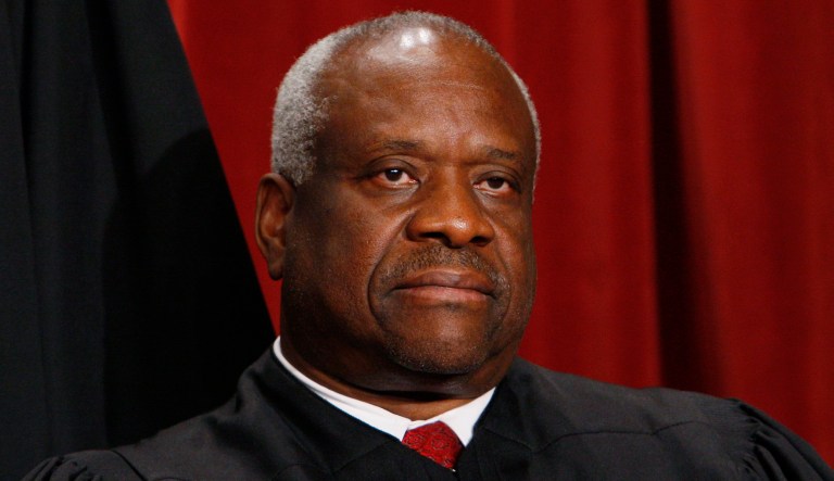 Associate Justice Clarence Thomas sits with other Supreme Court judges for a new group photograph, Tuesday, Sept. 29, 2009, at the Supreme Court in Washington.