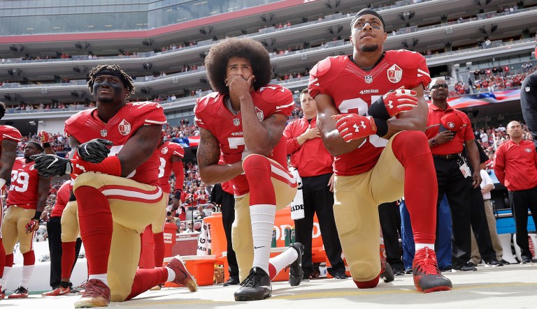 FILE - In this Oct. 2, 2016 file photo, from left, San Francisco 49ers outside linebacker Eli Harold, quarterback Colin Kaepernick and safety Eric Reid kneel during the national anthem before an NFL football game against the Dallas Cowboys in Santa Clara, Calif. In recent months, Colin Kaepernick has become comfortable with people knowing him as more than a laser-focused football player as he always previously preferred it. Perhaps, through the anthem protest and his emergence as an outspoken activist for minorities, Kaepernick has improved his image in the process.
