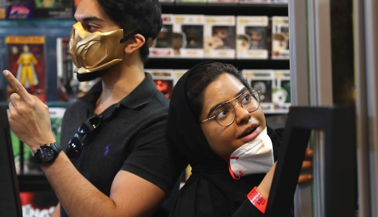 People wear face masks at the Middle East Comic Con in Dubai, United Arab Emirates, Thursday, March 5, 2020. The Middle East Film & Comic Con began Thursday night in Dubai, a city of skyscrapers and nightclubs suddenly subdued by the outbreak of the new virus across the region. The wider United Arab Emirates has at least 28 confirmed cases of the virus, a small number compared to the 3,750 cases regionwide, but the concern here is growing. 