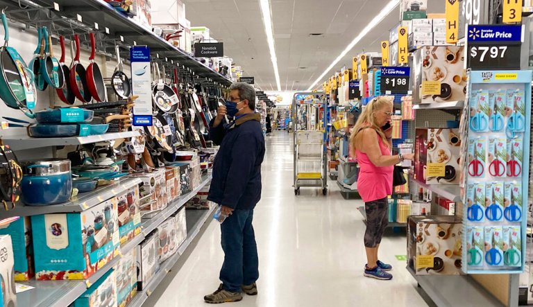 FILE - Consumers shop at a Walmart store in Vernon Hills, Ill., Sunday, May 23, 2021. U.S. consumer confidence fell in August to the lowest level since February amid rising concerns about the rapidly spreading delta variant of the coronavirus and worries about higher inflation. The Conference Board reported Tuesday, Aug. 31, 2021 that its consumer confidence index dropped to a reading of 113.8 in August, down from a revised 125.1 in July. 