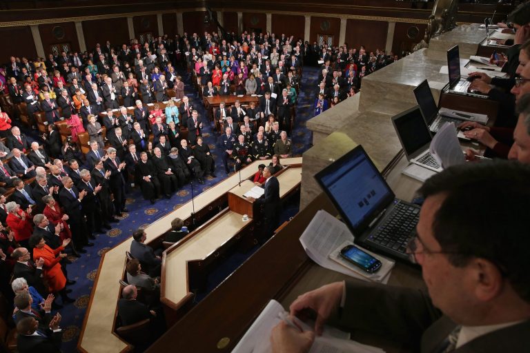 Reporters sit in a balcony behind President Obama as he delivers the State of the Union address to a joint session of Congress in the House Chamber at the U.S. Capitol on January 28, 2014 in Washington. (Photo by Chip Somodevilla/Getty images)