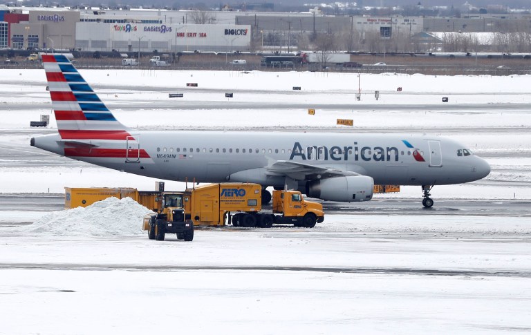 An American Airlines employee allegedly hit a woman with a stroller she brought on the plane, and video posted of the incident's aftermath has gone viral on social media. (AP Photo/Julio Cortez)
