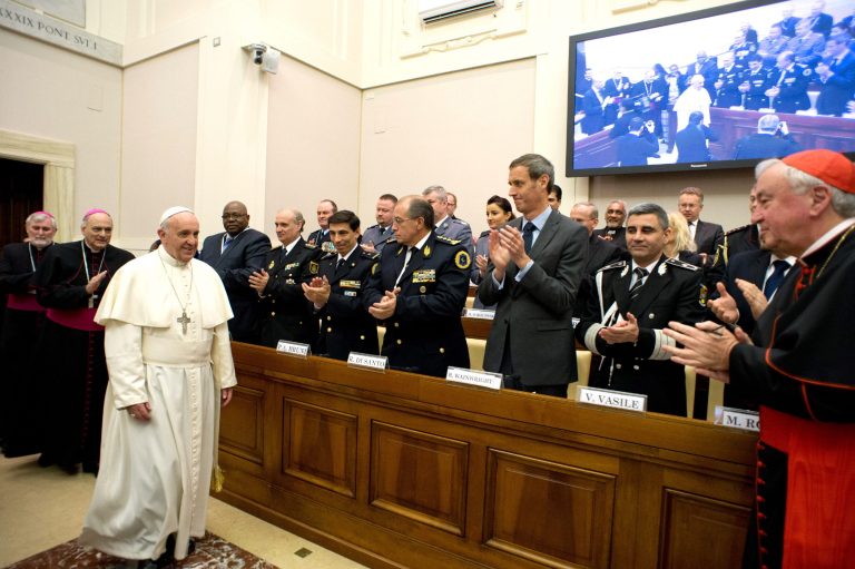 In this photo released by Vatican newspaper L'Osservatore Romano Pope Francis arrives at a conference about the human trafficking,  at the Vatican, Thursday, April 10, 2014. Pope Francis has denounced human trafficking as a crime against humanity after meeting with four women who were forced into prostitution.  Francis attended a Vatican conference Thursday of church workers, charity representatives and police chiefs from 20 nations, who pledged greater cooperation to encourage victims of trafficking and slavery to come forward.  (AP Photo/L'Osservatore Romano)