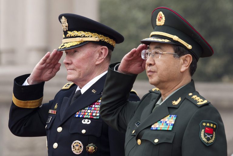 Joint Chiefs Chairman Gen. Martin Dempsey, left, and Chinese counterpart Gen. Fang Fenghui salute during a welcoming ceremony at the Bayi Building in Beijing. (AP/Andy Wong)