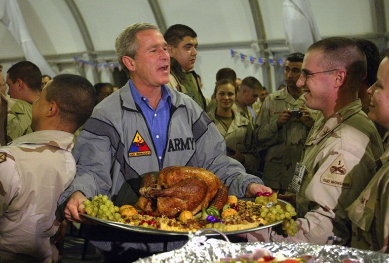 President George W. Bush made a surprise trip to Baghdad to have Thanksgiving dinner with the troops in 2003. (AP Photo/Anja Niedringhaus, File)