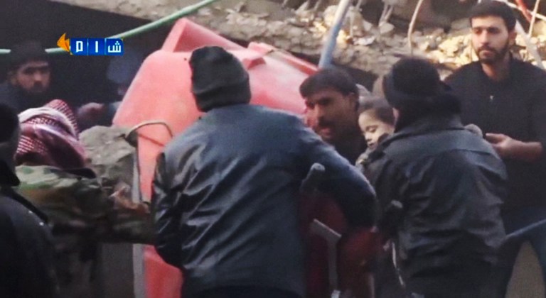 In this image made from Tuesday, Jan. 7, 2014, amateur video released by Ugarit News, which has been authenticated based on its contents and other AP reporting, people carry a girl out of rubble in Douma, Syria. In the town close to the Syrian capital of Damascus, several people were killed and wounded after a government airstrike targeted a house on Tuesday, reported the Observatory and another activist group, the Local Coordination Committees. (AP Photo/Ugarit News via AP Video)