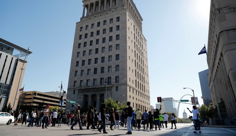 A group of protesters block the streets outside of the courthouse in downtown St. Louis, after a judge a white former St. Louis police officer not guilty of first-degree murder in the death of Anthony Lamar Smith, a black man who was fatally shot following a high-speed chase in 2011. (AP Photo/Jeff Roberson)