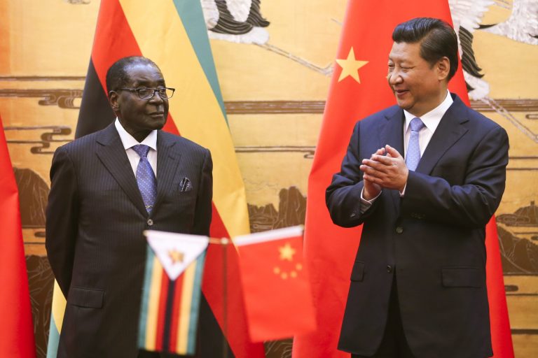 Zimbabwean President Robert Mugabe, left, looks on as his Chinese counterpart Xi Jinping applauds during a signing ceremony at the Great Hall of the People in Beijing, China, Monday, Aug. 25, 2014. Mugabe met with Xi on a visit to China hoping the long-time ally and economic giant can help the African nation's ailing economy. (AP Photo/Diego Azubel, Pool)