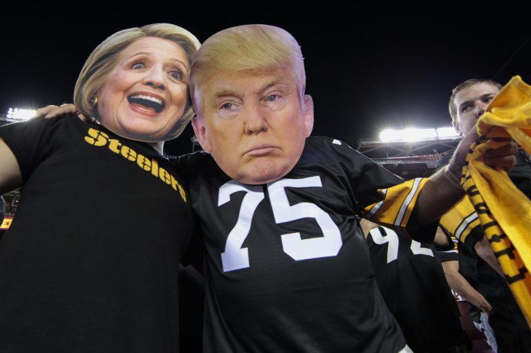 Pittsburgh Steelers fans Brian Picchini (left) and Rusty Kuchta (right) wear presidential candidates Sec. Hillary Clinton and Donald J. Trump masks during the first half of an NFL football game against the Washington Redskins in Landover, Md., Monday, Sept. 12, 2016. (AP Photo/Mark Tenally)