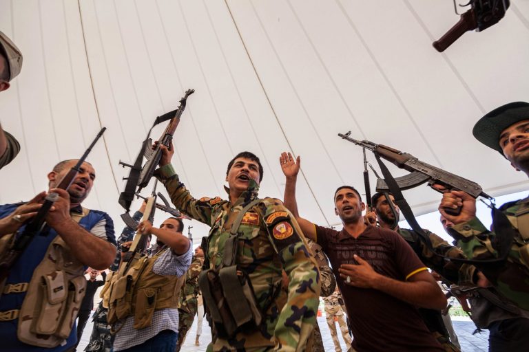 An Iraqi volunteer force chant slogans against the al-Qaida-inspired Islamic State of Iraq and the Levant during training in the Shiite holy city of Karbala, 50 miles (80 kilometers) south of Baghdad, Iraq, Wednesday, June 25, 2014, after authorities urged Iraqis to help battle insurgents. Shiite militias responding to a call to arms by Iraq's top cleric are focused on protecting the capital and Shiite shrines.(AP Photo/Ahmed al-Husseini)