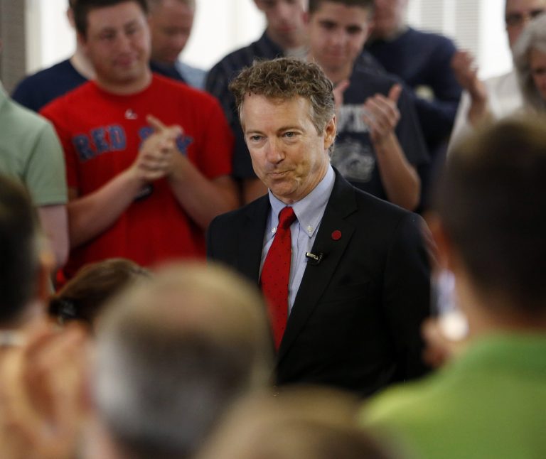 In this May 11, 2015 file photo, Republican presidential candidate, Sen. Rand Paul, R-Ky. acknowledges a cheering crowd as he introduced at a town hall meeting at the Loins Club hall with area residents, in Londonderry, N.H. (AP Photo/Jim Cole, File)