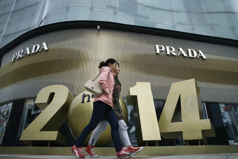Chinese women walk past a luxury fashion boutique at a shopping mall in Beijing, China Tuesday, Oct. 21, 2014. China's economic growth waned to a five-year low of 7.3 percent last quarter, raising concerns of a spillover effect on the global economy but falling roughly in line with Chinese leaders' plans for a controlled slowdown. (AP Photo/Andy Wong)