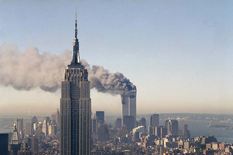In this Sept. 11, 2001, file photo, the twin towers of the World Trade Center burn behind the Empire State Building in New York. Families of the victims of the worst terror attack on the United States in history gathered Wednesday, Sept. 11, 2013, to mark their 12th anniversary with a moment of silence and the reading of names. (AP Photo/Marty Lederhandler, File)