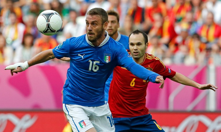   Italy's Daniele De Rossi, left, and Spain's Andres Iniesta duel for the ball during the Euro 2012 soccer championship Group C match between Spain and Italy in Gdansk, Poland, Sunday, June 10, 2012. (AP Photo/Gregorio Borgia)  