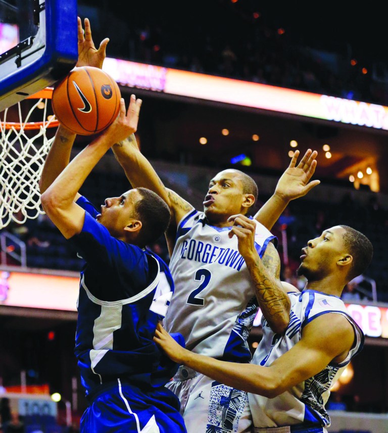 Alex Brandon/AP
Greg Whittington, center, Mikael Hopkins and Georgetown forced 30 turnovers in Monday's win over Longwood.