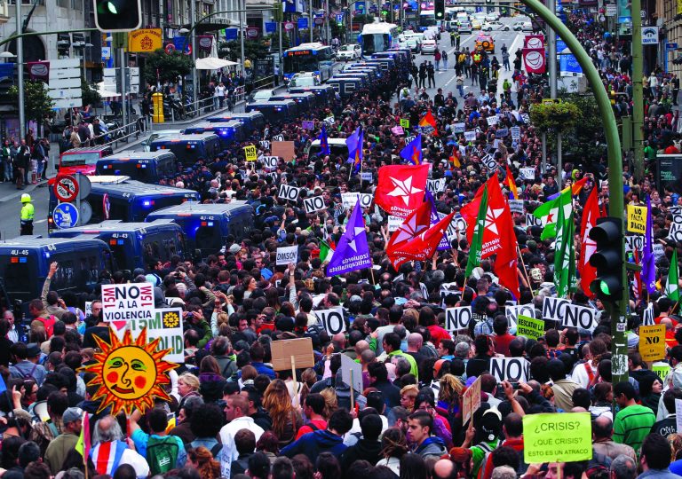 Protestors march to the parliament against austerity measures announced by the Spanish government, in Madrid, Spain, Tuesday, Sept. 25, 2012. Spain's Parliament has taken on the appearance of a heavily guarded fortress with dozens of police blocking access from every possible angle, hours ahead of a protest against the conservative government's handling of the economic crisis. The demonstration, organized behind the slogan 'Occupy Congress,' is expected to draw thousands of people. It is due to start around 1730 GMT Tuesday. Madrid authorities said some 1,300 police would be deployed. The protestors call for Parliament to be dissolved and fresh elections held, claiming the government's austerity measures show the ruling Popular Party misled voters to get elected last November. (AP Photo/Andres Kudacki)