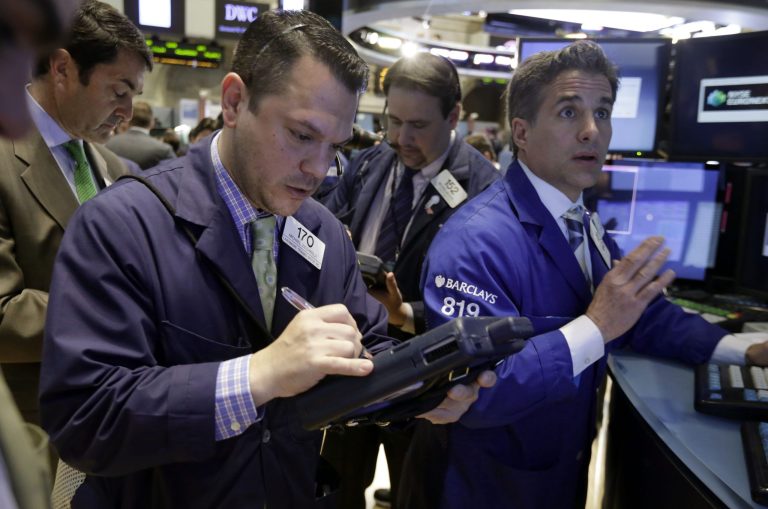 FILE - In this April 28, 2014 file photo, trader Michael Zicchinolfi, foreground left, and specialist Anthony Rinaldi, right, work on the floor of the New York Stock Exchange. Stocks are drifting lower in early trading Friday, May 9, 2014, as U.S. corporate earnings wind down. (AP Photo/Richard Drew, File)