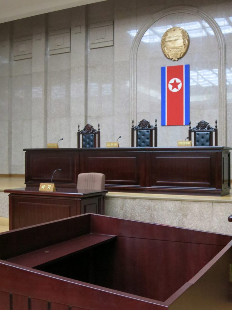 In this March 20, 2013 photo, a North Korean flag hangs inside the interior of Pyongyang's Supreme Court. North Korea says it will soon deliver a verdict in the case of detained American Kenneth Bae it accuses of trying to overthrow the government, further complicating already fraught relations between Pyongyang and Washington. The announcement about Bae comes in the middle of a lull after weeks of war threats and other provocative acts by North Korea against the U.S. and South Korea. Bae, identified in North Korean state media by his Korean name, Pae Jun Ho, is a tour operator of Korean descent who was arrested after arriving with a tour on Nov. 3 in Rason, a special economic zone bordering China and Russia. (AP Photo)