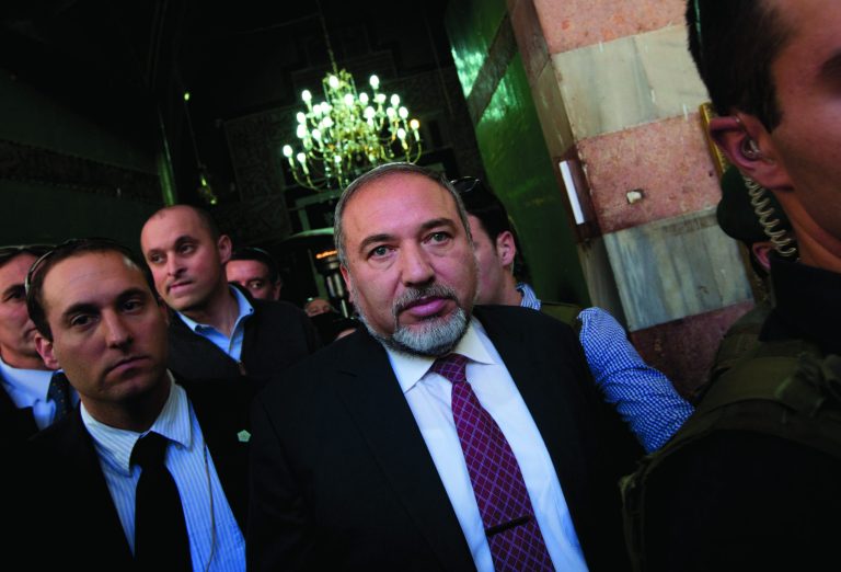 Israel's former Foreign Minister Avigdor Lieberman, center, visits the site known to Jews as the Tomb of the Patriarchs, and to Muslims as the Ibrahimi Mosque, in the West Bank city of Hebron, Monday, Jan. 14, 2013. Lieberman indicated on Monday that he would quit politics if convicted in his breach of trust and fraud case. (AP Photo/Bernat Armangue)