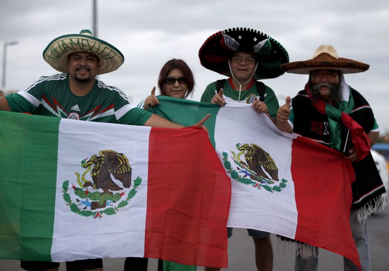 The Trejo family from Los Angeles poses outside of the Arena Castelao before the group A World Cup soccer match between Brazil and Mexico in Fortaleza, Brazil, Tuesday, June 17, 2014. A great number of fans that have come to Brazil to cheer for Mexico do not come from Mexico but rather from cities in the U.S. and entering Brazil with American passports. (AP Photo/Eduardo Verdugo)